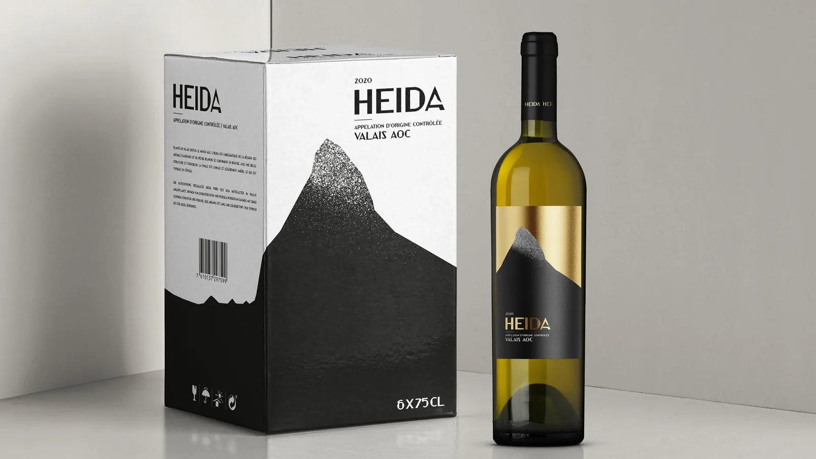 Caixa e garrafa do vinho Heida, Valais AOC, com montanha preta e dourada